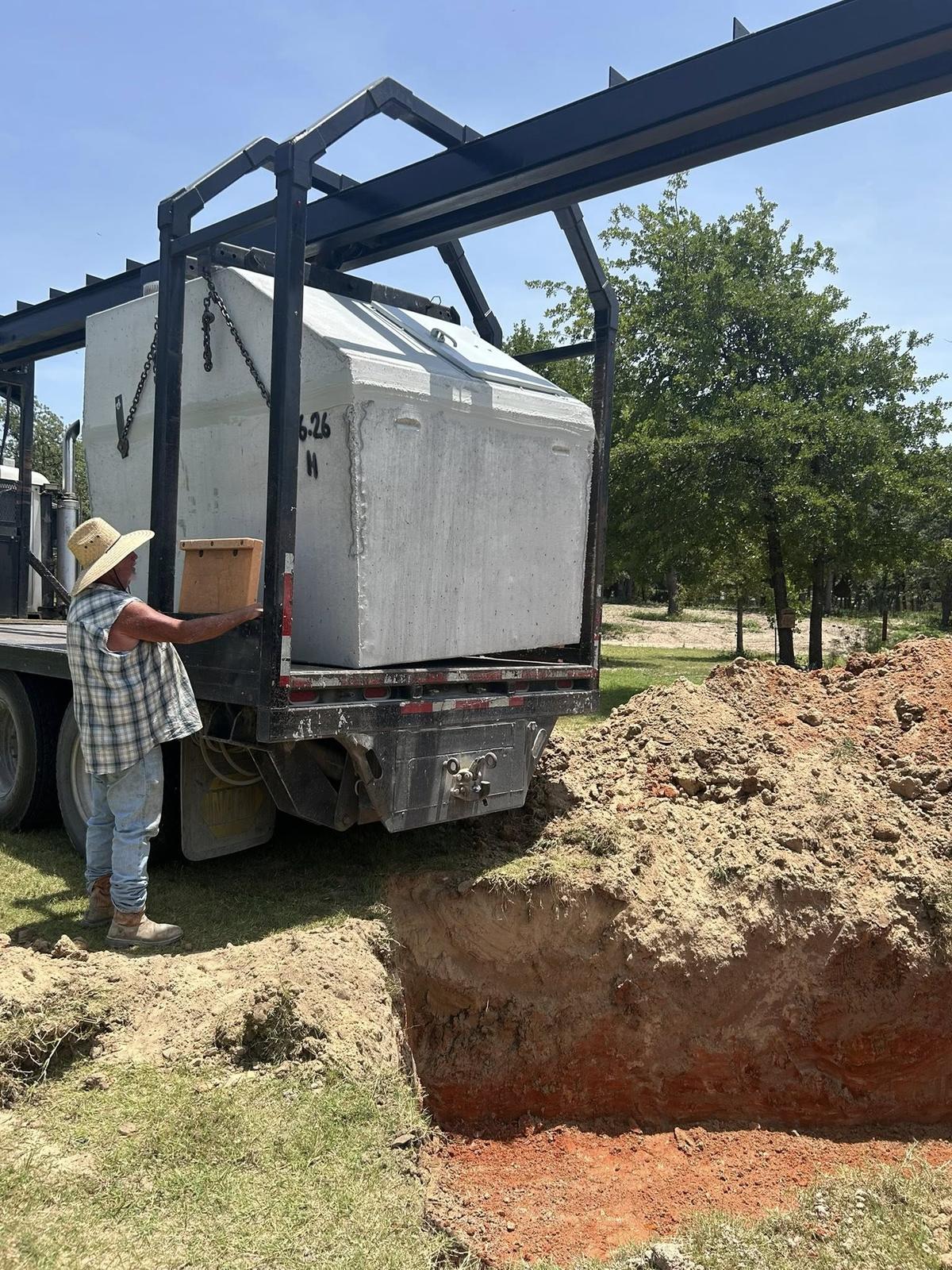 Lowering storm shelter into place